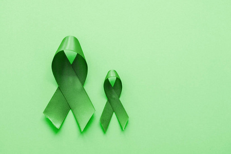 lime green ribbons on green background, mental health awareness