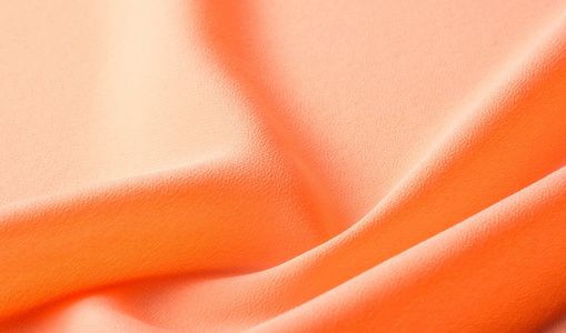 图片质感,背景橙色丝绸面料.它有一个奇迹照片