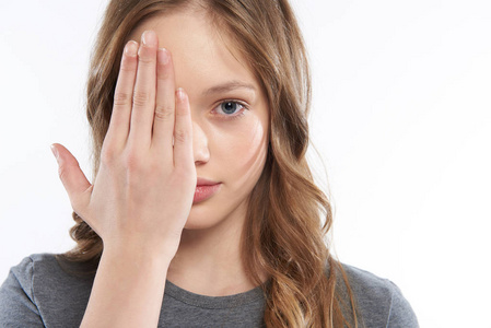 美丽的少女用手遮住半张脸照片