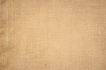 质感自然的麻布帆布面料.天然复古亚麻粗麻布编织,旧米色地毯背景.