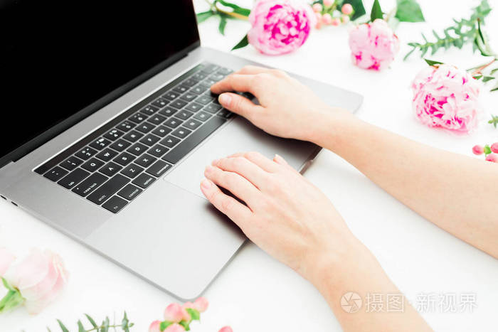 Woman typing on laptop. Workspace with female hands, laptop and 