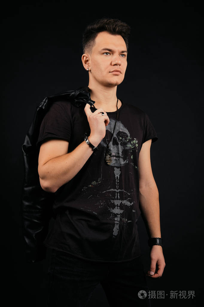 强壮自信的男人肩上扛着皮夹克