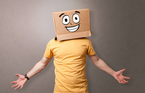 有着快乐的纸板盒脸的小男孩照片