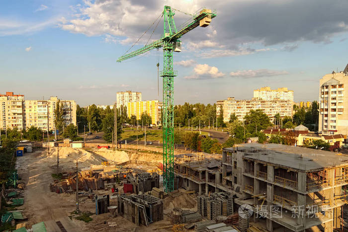 大城市高吊车施工现场夜间景观.在有旧建筑的地区建造新的住宅楼.乌克