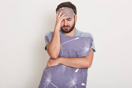 一张长相不错的白人男子在白色背景下孤零零地摆姿势,经历痛苦,看上去