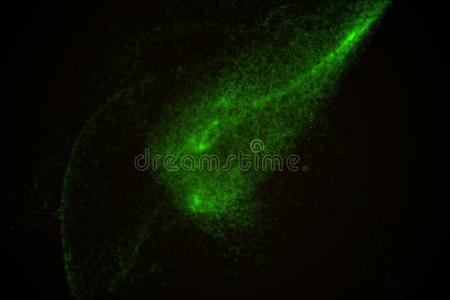 抽象的背景使关于绿色的灼热的微粒