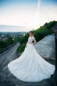 年幼的女孩采用wedd采用g衣服向城市背景在日落.夏