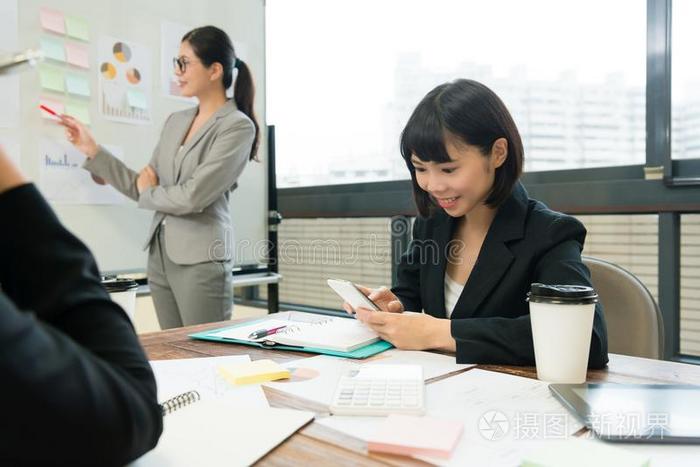 微笑的商业女人使用可移动的智能手机