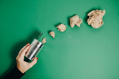 女人手和铝罐子和摺皱的纸向一绿色的b一ck