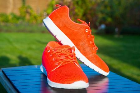 有关运动的鞋子旅游鞋明亮的桔子颜色.