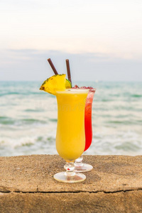 冰冷的鸡尾酒喝饮料玻璃和海和海滩