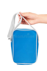 蓝色学校袋采用手隔离的向白色的背景.