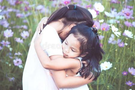 两个亚洲人小的女儿热烈地拥抱每别的和爱