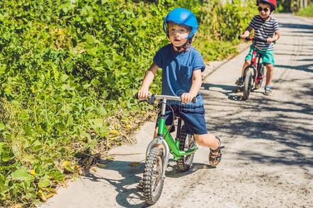 两个小的男孩孩子们所有乐趣向平衡自行车向一国家
