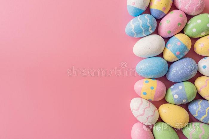 富有色彩的复活节卵向粉红色的彩色粉笔颜色背景和空间.