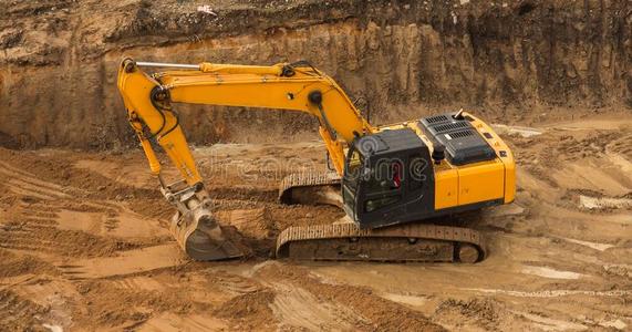 工作的开凿者拖拉机挖掘一沟.照片