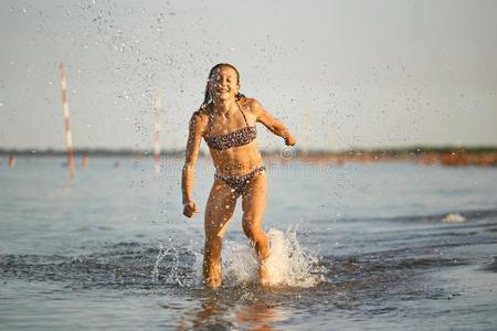 水乐趣.指已提到的人女孩跑一起指已提到的人海岸.