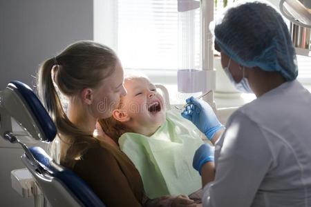 小的女孩和妈咪采用牙科医生房间