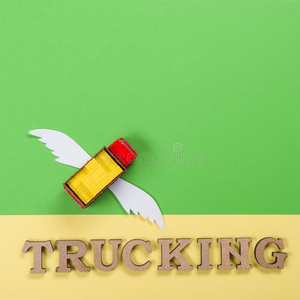 抽象的照片关于一货车和飞行章一nd一单词关于货车ing.英语字母表的第3个字母