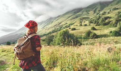 女人旅行者在顶关于山在日落在户外在的时候徒步旅行