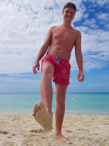 年幼的男人日光浴向指已提到的人海滩采用指已提到的人加勒比海海