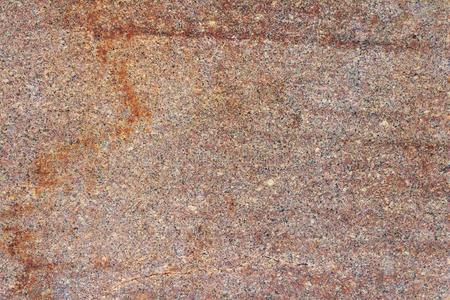 红色的花岗岩厚板和染色关-在上面.自然的石头质地
