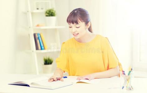 幸福的亚洲人年幼的女人学生学问在家