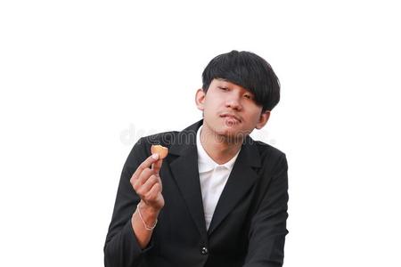 年幼的男人英俊的吃饼干小的一件向白色的背景