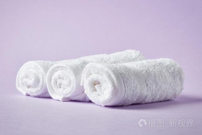 白色的休闲健身中心毛巾向紫色的背景