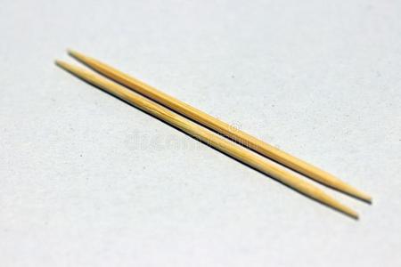 两个木制的牙签放向指已提到的人白色的地面.