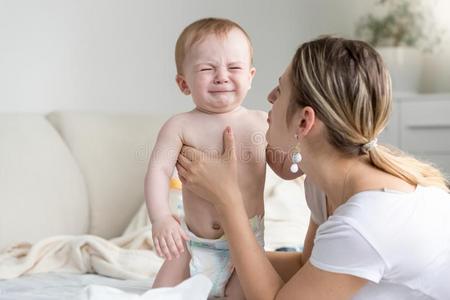 美丽的年幼的母亲爱抚的和平静下她极糟糕的巴巴拉的昵称