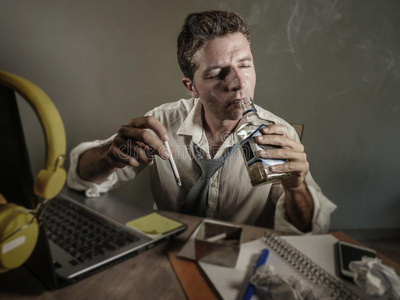 电脑中毒年幼的悲哀的和憔悴的凌乱的商业男人工作的在便携式电脑