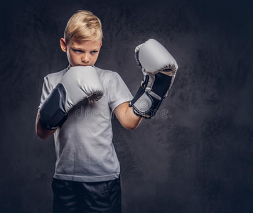 小拳击手练习一英俊的小的男孩拳击手和白肤金发碧眼女人头发打扮好的