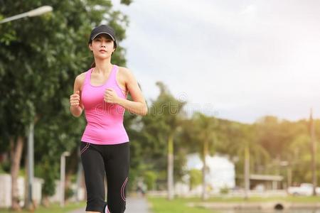 像运动家的女性的慢跑锻炼者早晨练习采用指已提到的人公园.照片