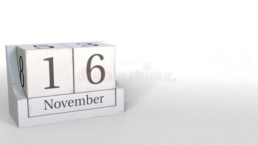 木材立方形日历给看十一月16日期,3英语字母表中的第四个字母翻译照片