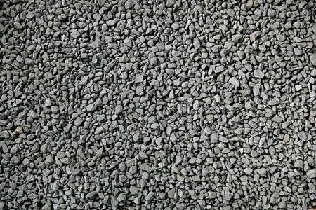 岩石铺路自然的灰色花岗岩碎屑,铺路用的碎石料,碎石或压碎的石头照片