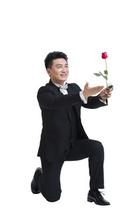 棚拍中年商务男士拿着一支玫瑰花