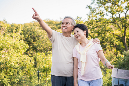一对老夫妻一对老夫妻老年夫妻旅游高级女人与她的狗躺在草地上一对老