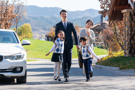 年轻夫妻送孩子去上学