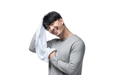 年轻男子在用毛巾擦头发照片
