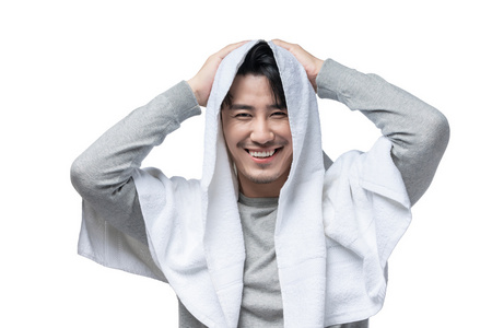年轻男子在用毛巾擦头发照片