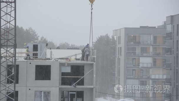 雪落和地盘工人盖房子在冬天视频