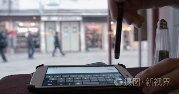 Woman typing sms with new phone number in cafe