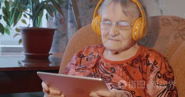 Grandmother using touch pad in wireless headphones