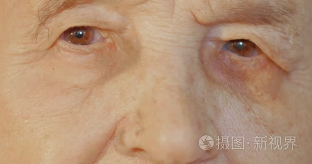 Elderly womans face with tired expression