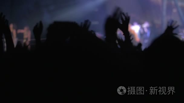 Fans waving hands on concert