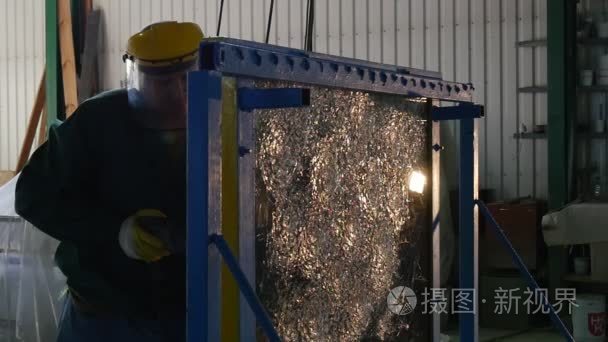 Worker in Uniform And Protective Screen is Drilling the Glass Sh