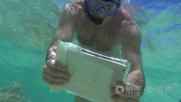 Man Shooting Coral Reef with Tablet PC