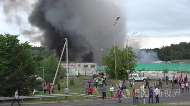 Fire balls of smoke and police surround area around burning ware