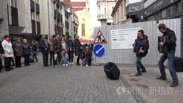 people audience enjoy men duo perform music with accordion. 4K